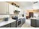 Charming kitchen with stainless steel appliances, white and gray cabinets, and an open layout at 17606 N 17Th Pl # 1054, Phoenix, AZ 85022