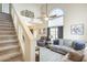 Open concept living room featuring wood-look tile floors and a staircase at 17606 N 17Th Pl # 1054, Phoenix, AZ 85022