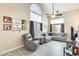 Sun-lit living room with wood-look tile floors, soaring ceilings, and a comfortable sectional sofa at 17606 N 17Th Pl # 1054, Phoenix, AZ 85022