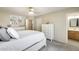 Bright main bedroom featuring white dressers, neutral walls, and adjoining ensuite bathroom for convenient access at 17606 N 17Th Pl # 1054, Phoenix, AZ 85022