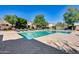 Beautiful community pool area surrounded by trees, lounge chairs, and shade umbrellas at 17606 N 17Th Pl # 1054, Phoenix, AZ 85022