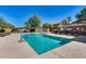 Community pool with clear blue water surrounded by lounge chairs and desert landscaping at 17606 N 17Th Pl # 1054, Phoenix, AZ 85022