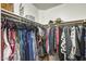 Organized walk-in closet featuring rods filled with hanging clothes, shelving, and neat storage solutions at 17606 N 17Th Pl # 1054, Phoenix, AZ 85022
