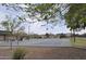 Well-maintained basketball court in a neighborhood park, surrounded by lush greenery at 17810 W Marshall Ln, Surprise, AZ 85388