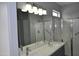 Bathroom with large mirror showing a shower with a glass door at 17810 W Marshall Ln, Surprise, AZ 85388