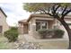 Inviting single-story home with stone detailing, desert landscaping, and a covered front porch at 17810 W Marshall Ln, Surprise, AZ 85388