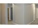 Hallway with hardwood floors with access to rooms and storage at 17810 W Marshall Ln, Surprise, AZ 85388