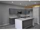 A spacious kitchen featuring gray cabinets, white countertops, and stainless steel appliances at 17810 W Marshall Ln, Surprise, AZ 85388