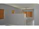 Spacious living area with faux-wood floors, gray walls, a ceiling fan, and natural light at 17810 W Marshall Ln, Surprise, AZ 85388