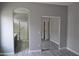 Open main bedroom showing bathroom entrance, closet and hard wood floors at 17810 W Marshall Ln, Surprise, AZ 85388