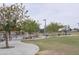 Daytime shot of a local park with a playground, trees, and walkways for community enjoyment at 17810 W Marshall Ln, Surprise, AZ 85388