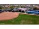 Aerial view of the community baseball field and tennis courts near the clubhouse at 18058 W Weatherby Dr, Surprise, AZ 85374