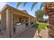 Covered patio area with built in BBQ, ceiling fans and outdoor seating area at 18058 W Weatherby Dr, Surprise, AZ 85374