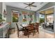 Inviting dining area with a wooden table, comfortable chairs, and windows providing backyard views at 18058 W Weatherby Dr, Surprise, AZ 85374