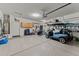 Spacious garage with ample storage space, golf cart and epoxy floor at 18058 W Weatherby Dr, Surprise, AZ 85374