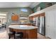 Well-equipped kitchen featuring a center island, stainless steel appliances, and light wood cabinets at 18058 W Weatherby Dr, Surprise, AZ 85374