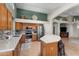 Bright kitchen featuring stainless steel appliances, a kitchen island with seating, and natural lighting at 18058 W Weatherby Dr, Surprise, AZ 85374