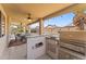 The outdoor kitchen boasts a built-in grill and bar seating for outdoor dining and entertaining at 18058 W Weatherby Dr, Surprise, AZ 85374