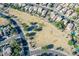 Aerial view of neighborhood park and green space with walking path and playground at 18525 N Larkspur Dr, Maricopa, AZ 85138