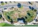 Overhead view features a community park with walking trails, lush landscapes, and a covered picnic area at 18525 N Larkspur Dr, Maricopa, AZ 85138