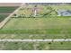 Aerial view displaying a community park with baseball diamonds, soccer fields, and recreational green spaces at 18525 N Larkspur Dr, Maricopa, AZ 85138