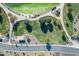 Overhead view showcases a meticulously landscaped community park with walking paths and verdant green spaces at 18525 N Larkspur Dr, Maricopa, AZ 85138
