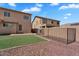 Fenced backyard with artificial turf, surrounded by gravel landscaping for easy upkeep at 18525 N Larkspur Dr, Maricopa, AZ 85138