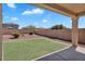 Inviting backyard with covered patio and well-maintained turf, perfect for entertaining at 18525 N Larkspur Dr, Maricopa, AZ 85138