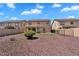 Large backyard with rock landscaping, small lawn, and a privacy fence for outdoor enjoyment at 18525 N Larkspur Dr, Maricopa, AZ 85138