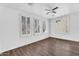 Spacious bedroom features hard surface floors and natural light streaming through shuttered windows at 18525 N Larkspur Dr, Maricopa, AZ 85138