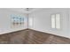 Spacious bedroom featuring hardwood floors, natural light, and plantation shutters at 18525 N Larkspur Dr, Maricopa, AZ 85138