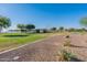 Scenic community park includes lake views, green spaces, recreational facilities, and pedestrian pathways for outdoor activities at 18525 N Larkspur Dr, Maricopa, AZ 85138