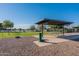 Well-equipped dog park with shade structure, water bowls, and agility equipment, ensuring a comfortable and fun experience at 18525 N Larkspur Dr, Maricopa, AZ 85138