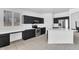 Modern kitchen with black cabinets, stainless steel appliances, and a bright island at 18525 N Larkspur Dr, Maricopa, AZ 85138