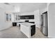 Well-lit kitchen with black cabinets, stainless steel appliances, and a stylish central island at 18525 N Larkspur Dr, Maricopa, AZ 85138