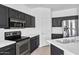 Close up of kitchen with stainless steel oven, cooktop, and white countertops at 18525 N Larkspur Dr, Maricopa, AZ 85138