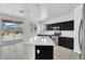 Modern kitchen with island featuring sink, stainless steel appliances, and outdoor access at 18525 N Larkspur Dr, Maricopa, AZ 85138