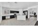 Bright kitchen with black cabinets, stainless steel appliances, and tiled flooring at 18525 N Larkspur Dr, Maricopa, AZ 85138