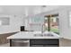 Modern kitchen featuring an island with a stainless steel sink, faucet, and dishwasher at 18525 N Larkspur Dr, Maricopa, AZ 85138