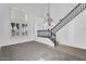 Bright landing area with high ceilings, staircase, and large windows, providing ample natural light at 18525 N Larkspur Dr, Maricopa, AZ 85138
