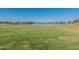 Serene park featuring a scenic lake with a fountain, offering a peaceful retreat and recreational space for residents at 18525 N Larkspur Dr, Maricopa, AZ 85138
