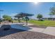 Community picnic area offering covered seating, green spaces, and views of the adjacent lake and landscaped park at 18525 N Larkspur Dr, Maricopa, AZ 85138