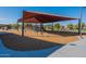 Shaded community playground featuring climbing structures and a slide, creating a safe and engaging environment for children to play at 18525 N Larkspur Dr, Maricopa, AZ 85138