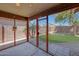 Cozy screened-in back porch provides views of the grassy backyard at 18590 W Vogel Ave, Goodyear, AZ 85338