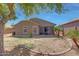 Charming home featuring a private backyard with lush landscaping and a mature shade tree at 18590 W Vogel Ave, Goodyear, AZ 85338