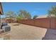 Large backyard with gravel and a privacy wall, perfect for outdoor entertaining at 18590 W Vogel Ave, Goodyear, AZ 85338