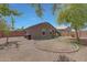 Spacious backyard featuring desert landscaping, a tree and a block wall at 18590 W Vogel Ave, Goodyear, AZ 85338