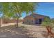 Spacious backyard with a mature tree, a brick wall, and pavers at 18590 W Vogel Ave, Goodyear, AZ 85338