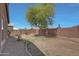 Well-maintained backyard featuring desert landscaping, mature trees, and a brick perimeter at 18590 W Vogel Ave, Goodyear, AZ 85338