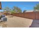 Backyard showing gravel landscaping, brick fence, and seating area at 18590 W Vogel Ave, Goodyear, AZ 85338